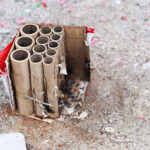 Used fireworks firecrackers lying on snow after exploding in celebration.